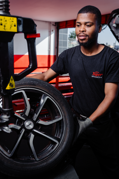 Tyre Rotation A Tiger Wheel & Tyre technician performing a technical procedure.
