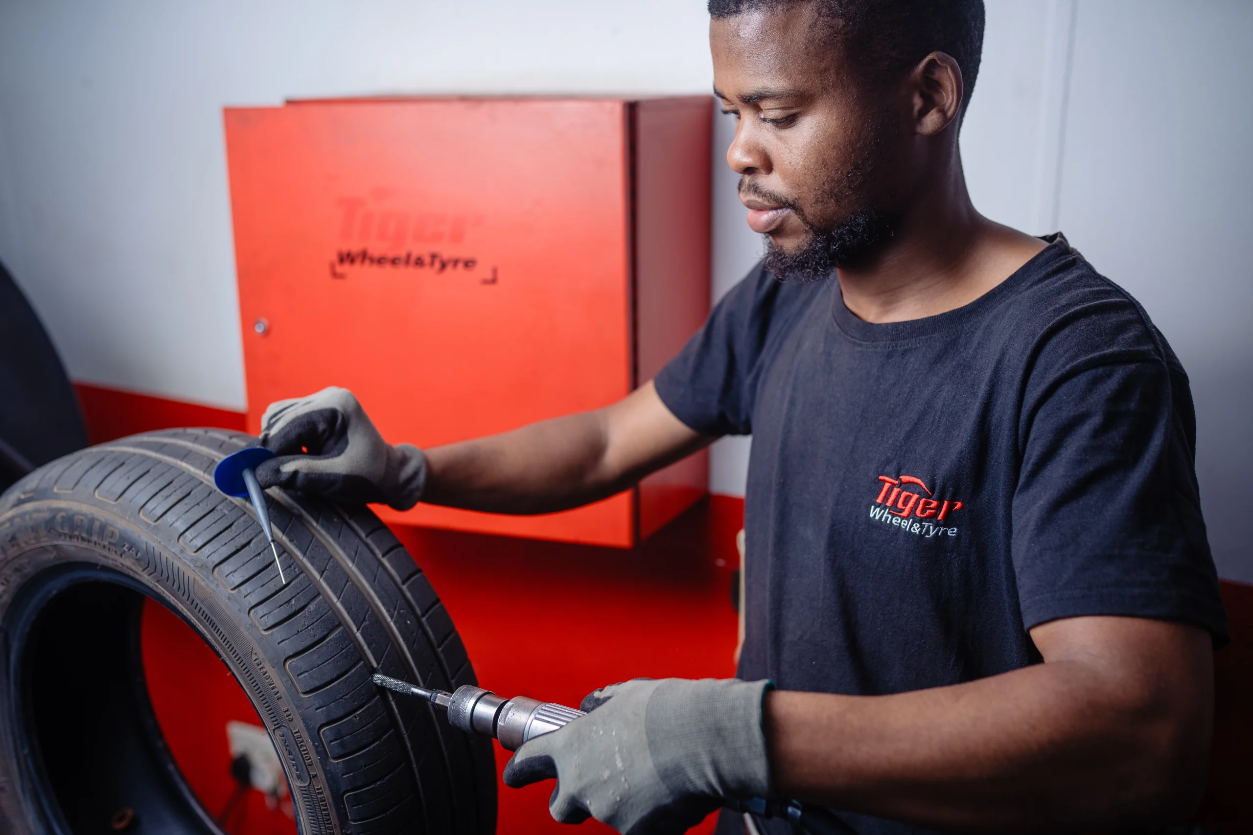 A Tiger Wheel & Tyre technician performing a Tyre Puncture Repair